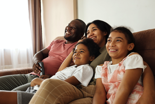 A black family watching tv 